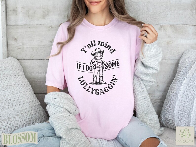Pink t-shirt with "Y'all mind IF I DO SOME LOLLYGAGGIN'" text and frog graphic.