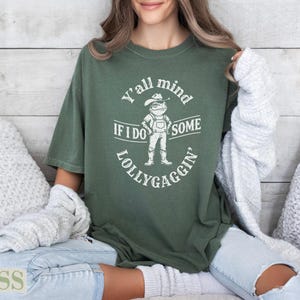 Green t-shirt with "Y'all mind if I do some lollygaggin'" text and frog graphic.