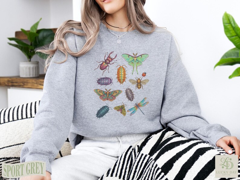 Grey sweatshirt with colorful insect illustrations, including beetles and moths.