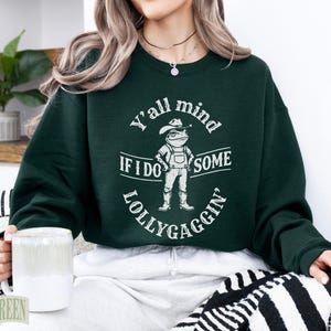 Green sweatshirt with frog graphic and "Y'all mind if I do some lollygaggin" text.