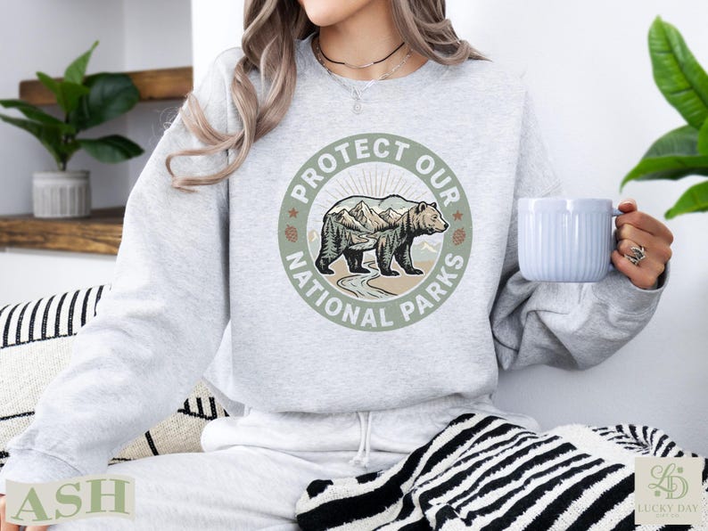 Light grey sweatshirt with "Protect Our National Parks" circular graphic featuring a bear.