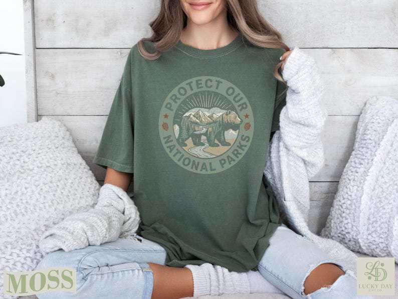 Green t-shirt with "Protect Our National Parks" text and bear illustration.