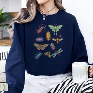 Navy sweatshirt with illustrations of various insects and bugs.
