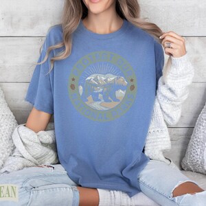 Blue t-shirt with a "Protect Our National Parks" circular graphic featuring a bear and mountains.