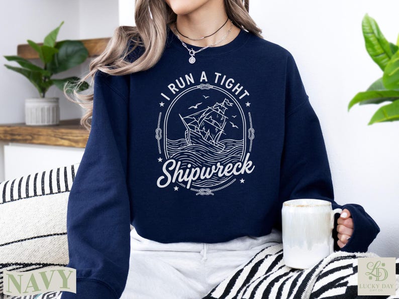 Navy sweatshirt with "I Run A Tight Shipwreck" nautical ship graphic.