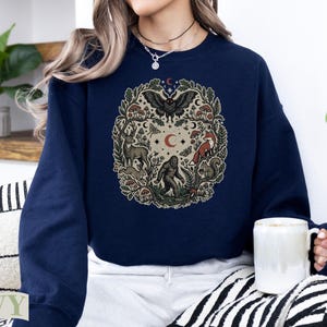 Navy crewneck sweatshirt with woodland creature circle design.