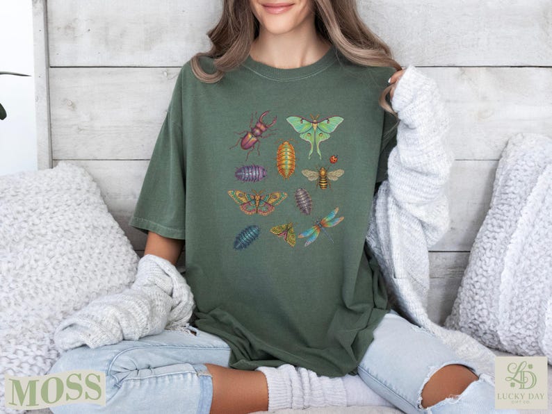 Green t-shirt with colorful insect illustrations and "Moss" text.