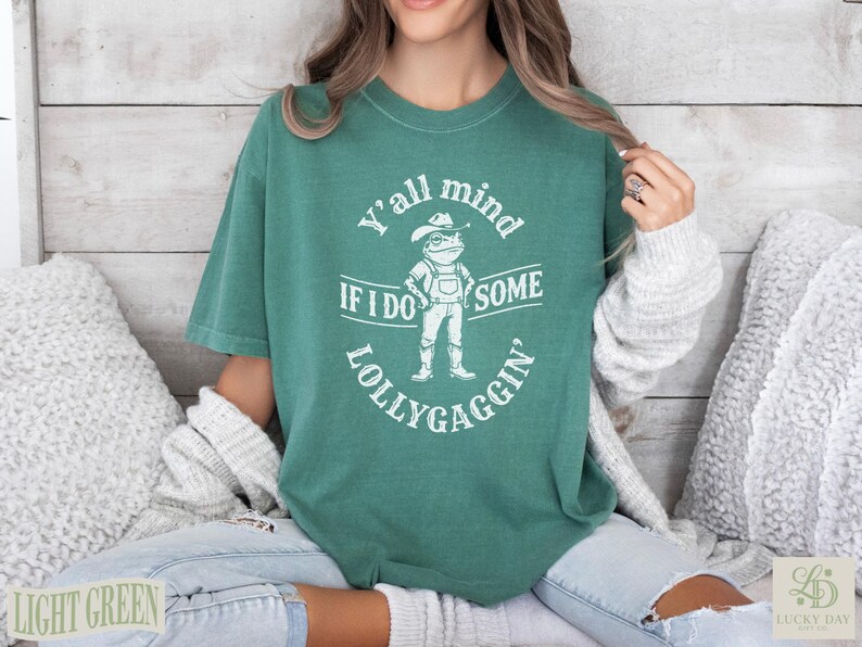Green t-shirt with frog design and "Y'all mind if I do some lollygaggin'" text.