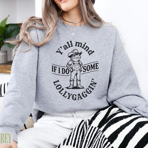 Grey sweatshirt with "Y'all mind if I do some lollygaggin'" graphic.