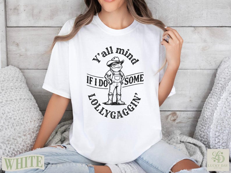 White t-shirt with "Y'all mind if I do some lollygaggin'" and cartoon figure.
