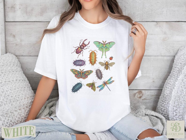 White t-shirt with colorful insect illustrations including beetles, moths, and dragonflies.