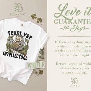 White t-shirt with opossum reading book and "Feral Yet Intellectual" text.