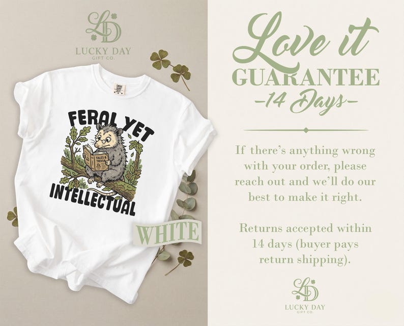 White t-shirt with opossum reading book and "Feral Yet Intellectual" text.