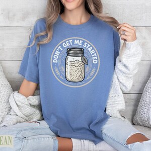 Blue t-shirt with "Don't Get Me Started" and sourdough jar graphic.