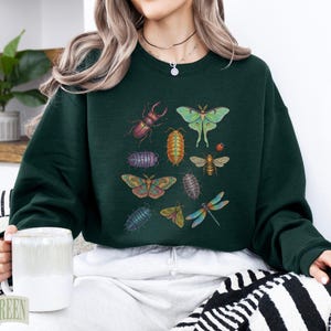 Dark green crewneck sweatshirt featuring various insects in a collage.