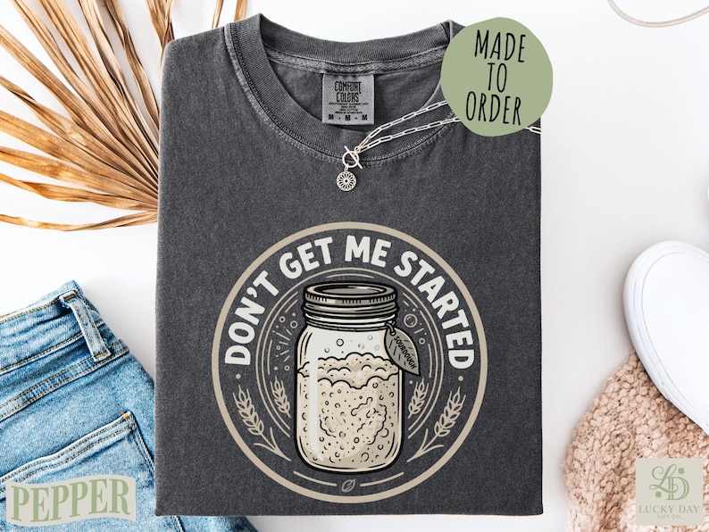 Dark gray t-shirt with "Don't Get Me Started" and a jar illustration.