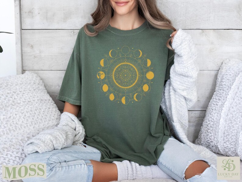 Green t-shirt with gold moon phases and mandala design.