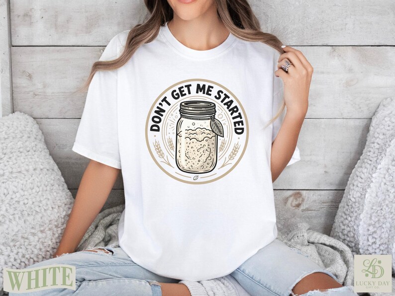 White t-shirt with circular graphic of a jar of starter and the text "Don't Get Me Started".