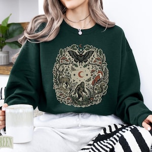Dark green crewneck sweatshirt with forest animal circular graphic.