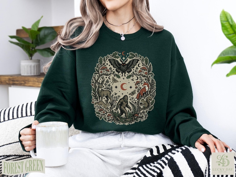 Dark green crewneck sweatshirt with forest animal circular graphic.
