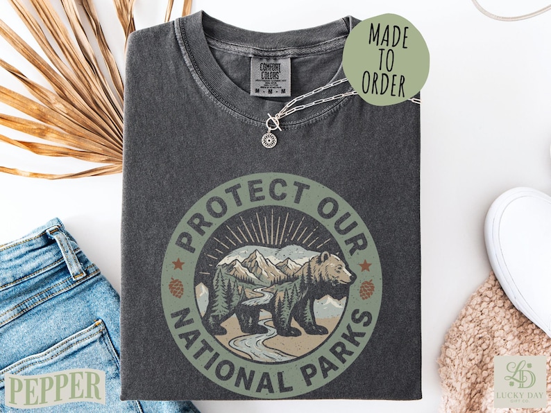 Dark gray t-shirt with "Protect Our National Parks" text and bear graphic.