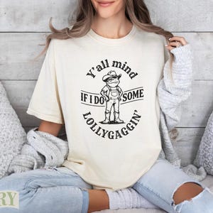 Cream t-shirt with frog graphic and "Y'all mind if I do some lollygaggin'" text.