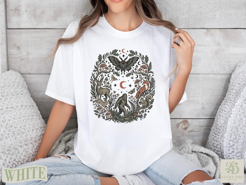 White t-shirt with circular woodland creature and nature design.