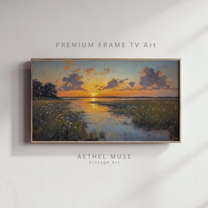 Può includere: Dipinto di paesaggio incorniciato raffigurante un tramonto su una palude. L'opera presenta un cielo vibrante con tonalità arancioni e gialle, che si riflettono nell'acqua. Il testo "PREMIUM FRAME TV Art" e "AETHEL MUSE Vintage Art" sono visibili.