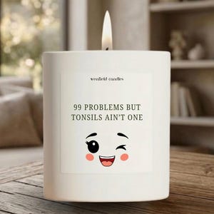 May include: A white ceramic mug with a black handle and the text "But First, Coffee" in a black, bold font. The mug is sitting on a white surface. The mug is approximately 4 inches tall.