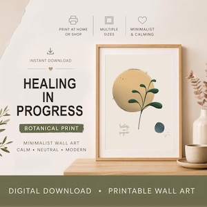 May include: A framed botanical print with the text "Healing in Progress." The artwork features a yellow sphere with green leaves and a blue dot. The print is displayed on a wooden surface with a vase and books.
