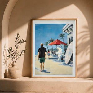 May include: A framed wall art print depicting a beach scene with a person in a black t-shirt and green shorts walking on sand. The scene includes a red umbrella, a white dolphin statue holding a sign that reads SEAFOOD, and a surfboard.