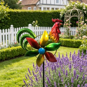 May include: A colorful metal rooster garden stake with a flower-shaped spinner. The rooster is red and yellow, and the spinner has red, yellow, and green petals with a blue center. The stake is in a garden with a white picket fence and lavender.