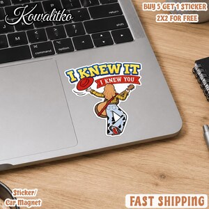May include: A die-cut sticker featuring a cartoon figure with long hair wearing a yellow plaid shirt and cow-print bell-bottom pants, holding a guitar and a red hat. The text reads I KNEW IT I KNEW YOU in blue and red against a white background.
