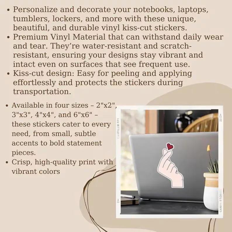 May include: A vinyl kiss-cut sticker featuring a hand making a finger heart gesture with a small red heart above it. The sticker is applied to a laptop. Text on the image lists features including water-resistance, scratch-resistance, and four sizes: 2"x2", 3"x3", 4"x4", and 6"x6".