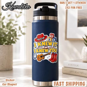 May include: A dark blue stainless steel water bottle with a black lid. The bottle features a sticker with a red cowboy hat, a guitar, red boots, and blocks with the letters T, S, and 5. The text reads I KNEW IT I KNEW YOU.