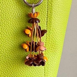 Keke’s leather tassely flower keychain, zipper pull and purse charms - assorted colors