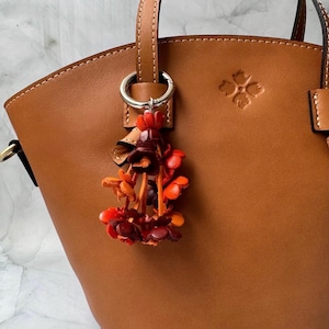 Keke’s leather tassely flower keychain, zipper pull and purse charms - assorted colors
