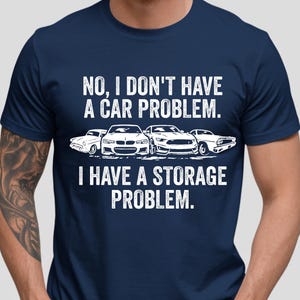 May include: Navy blue t-shirt with a white graphic of three cars and the text: "NO, I DON'T HAVE A CAR PROBLEM. I HAVE A STORAGE PROBLEM."