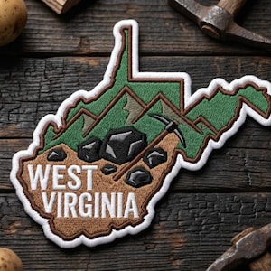 May include: Embroidered patch in the shape of West Virginia, featuring green mountains, a pickaxe, and the text "WEST VIRGINIA" in white. The patch is on a dark wooden surface with potatoes and tools.