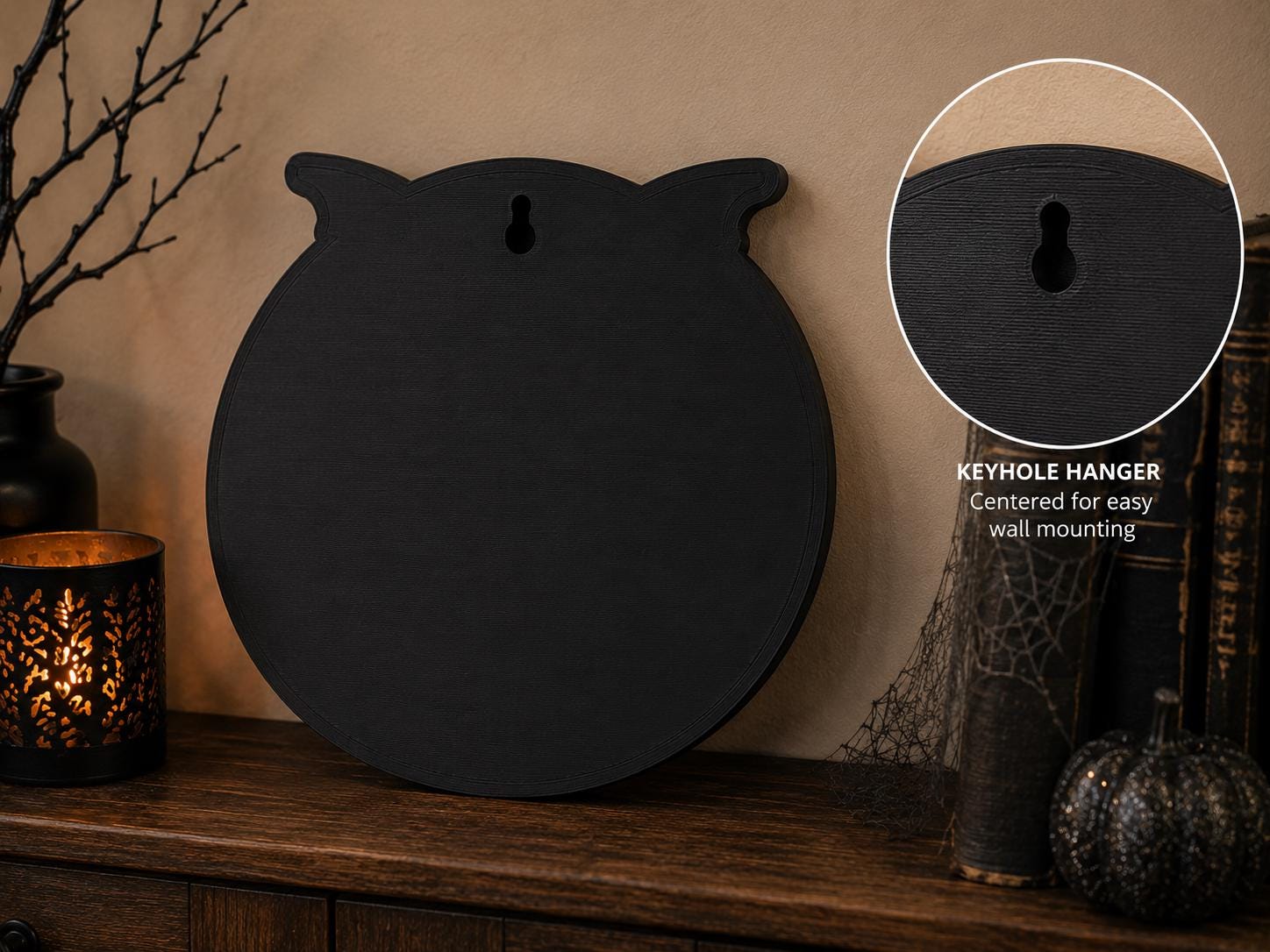 The reverse side of the circular black sign showing a keyhole hanger for mounting it on a wall.