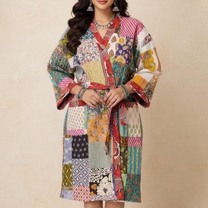 May include: A vibrant patchwork robe with a V-neck and long sleeves. The robe is made from various patterned fabric squares in red, pink, blue, green, and yellow. It has a matching belt and falls to the knees.