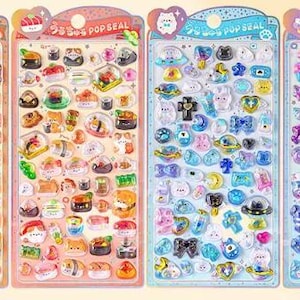 May include: Four vertical sheets of puffy stickers labeled Pop Seal, featuring various designs. The first two sheets display food and animal motifs in warm tones, while the last two sheets showcase blue and purple space and aquatic themes.