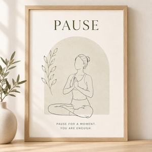 May include: A framed wall art print featuring a line drawing of a person in a seated yoga pose with hands together. The design includes a beige arch, a leafy branch, and the text PAUSE at the top and PAUSE FOR A MOMENT. YOU ARE ENOUGH. at the bottom.