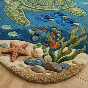 May include: A detailed rug featuring an underwater scene with a sea turtle, colorful fish, starfish, and seashells. The rug has a blue background with tan and green accents, creating a vibrant and textured design. The rug's dimensions are not visible.