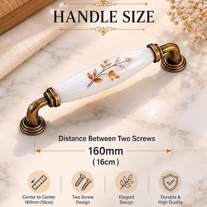 May include: A white and gold floral design cabinet handle with antique brass hardware. The handle's center-to-center distance is 160mm (6.3 inches). The image also includes the text "HANDLE SIZE".