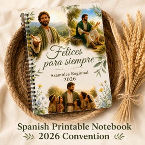 May include: A spiral-bound notebook with a religious theme, featuring illustrations of a man in a robe and the text "Felices para siempre" and "Asamblea Regional 2026." The notebook is set in a woven basket with wheat stalks.