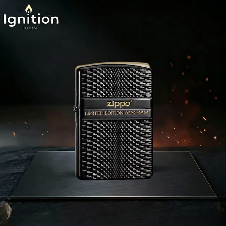 May include: Black Zippo lighter with a geometric pattern. The lighter has a gold-colored top and a black band with the Zippo logo and "LIMITED EDITION 0299/9999" text. The "Ignition House" logo is in the top left corner.