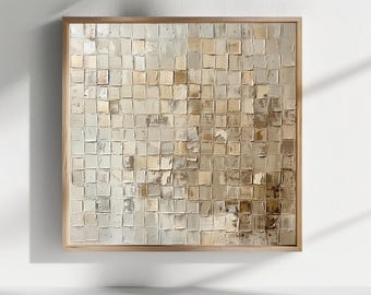 May include: A square wall art piece featuring a grid of small, raised, textured squares in varying shades of beige, cream, tan, and metallic gold. The artwork is encased in a light-toned wooden frame, displaying a thick, impasto paint application.