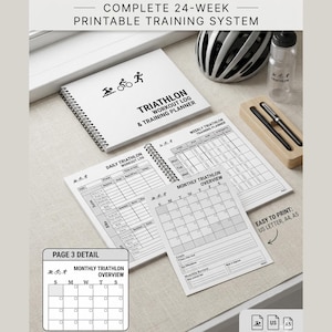 May include: A white spiral-bound triathlon workout log and training planner with the text "TRIATHLON WORKOUT LOG & TRAINING PLANNER". Includes daily, weekly, and monthly training pages. Also includes a water bottle and a bicycle helmet.