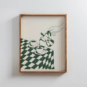 May include: Framed print depicting a green and white chequered tablecloth with two cups and saucers. A hand pours coffee from a stovetop espresso maker into a cup. The artwork is in a minimalist style.